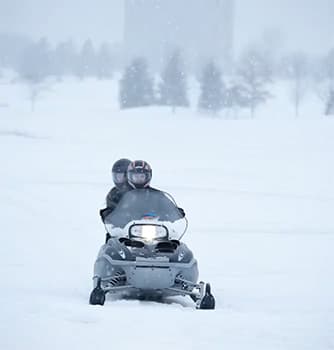 A couple on a snowmobile