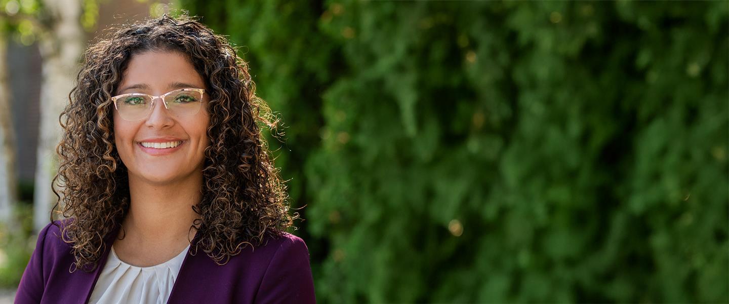 Smiling employee Maria outside. 