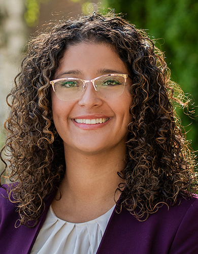 Smiling employee Maria outside. 