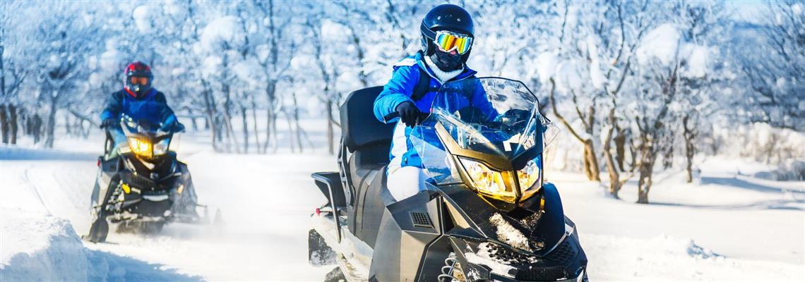 Snowmobiles on a trail