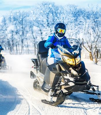 Snowmobiles on a trail