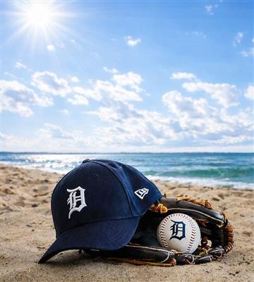 Detroit Tigers hat sitting on beach with baseball and mitt
